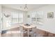 Bright dining room with hardwood floors, large windows, a light fixture, and views of the front yard at 11618 Macallano Dr, Charlotte, NC 28215