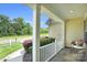 Inviting front porch with wicker seating, offering a view of the landscaped yard at 11618 Macallano Dr, Charlotte, NC 28215