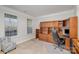 Cozy home office with built-in wooden cabinets, drawers, shelving, and large windows at 11618 Macallano Dr, Charlotte, NC 28215