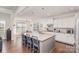 Bright eat-in kitchen with white cabinets, granite countertops, an island with seating, and stainless appliances at 11618 Macallano Dr, Charlotte, NC 28215
