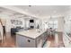 Open kitchen and living room with a large island with a sink, stainless appliances, and modern finishes at 11618 Macallano Dr, Charlotte, NC 28215
