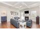 Cozy living room with a fireplace, coffered ceiling, hardwood floors, and comfortable seating at 11618 Macallano Dr, Charlotte, NC 28215