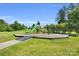 Community playground with slides, climbing structures, and walking path on grassy area at 11618 Macallano Dr, Charlotte, NC 28215
