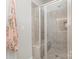 Walk-in shower with glass enclosure and tiled walls at 11618 Macallano Dr, Charlotte, NC 28215