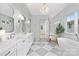 Bright bathroom featuring double vanity, freestanding tub, glass shower and checkered tile flooring at 1321 Ferncliff Rd, Charlotte, NC 28211
