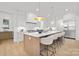 Modern kitchen with large island, pendant lighting, and stainless steel appliances at 1321 Ferncliff Rd, Charlotte, NC 28211