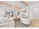 Open living room featuring fireplace, exposed beams, and neutral decor at 1321 Ferncliff Rd, Charlotte, NC 28211