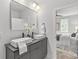 Stylish bathroom with double sinks, elegant fixtures, and a view into a bright bedroom with a large bed at 1356 Briar Creek Rd, Charlotte, NC 28205
