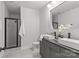 Modern bathroom with double sink vanity, sleek fixtures, and glass-enclosed shower showcasing contemporary design at 1356 Briar Creek Rd, Charlotte, NC 28205