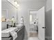 Elegant bathroom with double vanity, modern fixtures, and doorway to a well-lit bedroom at 1356 Briar Creek Rd, Charlotte, NC 28205