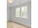 Bright bedroom with two large windows offering views of lush greenery, showcasing a peaceful ambiance at 1356 Briar Creek Rd, Charlotte, NC 28205