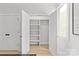 Bright closet featuring built-in shelving and a wooden hanging rod, offering ample storage space at 1356 Briar Creek Rd, Charlotte, NC 28205