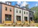 Modern townhomes feature varied colors, gray doors and wood stairs, enhancing curb appeal at 1356 Briar Creek Rd, Charlotte, NC 28205