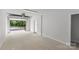 Garage with door opening to reveal outdoor greenery at 1356 Briar Creek Rd, Charlotte, NC 28205