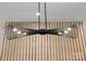 Unique contemporary lighting fixture against a decorative slatted wood wall, enhancing modern design elements at 1356 Briar Creek Rd, Charlotte, NC 28205