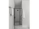 Modern shower with black-framed glass door, textured tile walls, and sleek fixtures at 1356 Briar Creek Rd, Charlotte, NC 28205