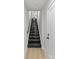 Dark staircase with white trim and wood floors at 1356 Briar Creek Rd, Charlotte, NC 28205
