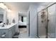 Modern bathroom featuring double sinks, white cabinets, and a glass-enclosed shower with tile at 154 Stella Ln # A, Troutman, NC 28166