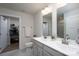 Bright bathroom featuring a dual sink vanity, walk-in closet, neutral color palette, and tile flooring at 154 Stella Ln # A, Troutman, NC 28166