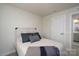 Well-lit bedroom with a farmhouse-style headboard and access to a bathroom at 154 Stella Ln # A, Troutman, NC 28166