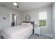 Bedroom featuring a ceiling fan, large window, and an ensuite closet at 154 Stella Ln # A, Troutman, NC 28166