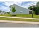 Side view of home featuring blue siding, manicured lawn, and a screened-in porch at 154 Stella Ln # A, Troutman, NC 28166