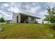 Backyard view featuring a screened-in porch, well-maintained lawn, and privacy fence at 154 Stella Ln # A, Troutman, NC 28166