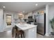 Bright kitchen featuring white cabinets, an island with seating, and stainless steel appliances at 154 Stella Ln # A, Troutman, NC 28166