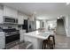 Modern kitchen with stainless steel appliances, white countertops, and an island with seating at 154 Stella Ln # A, Troutman, NC 28166