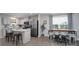Open concept kitchen featuring white cabinets, stainless appliances, and an adjacent dining area at 154 Stella Ln # A, Troutman, NC 28166