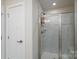 Tiled shower with a glass door enclosure and neutral color palette at 154 Stella Ln # A, Troutman, NC 28166