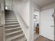 Carpeted staircase leading to the upper level, with natural light and access to the laundry room at 154 Stella Ln # A, Troutman, NC 28166