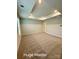 Expansive main bedroom with plush carpeting, tray ceiling and recessed lighting, offering a serene and luxurious retreat at 1598 Respect St, Concord, NC 28027