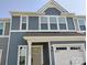 Charming two-story townhome with blue siding, white trim, and an attached one car garage at 1598 Respect St, Concord, NC 28027
