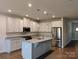Bright and modern kitchen features an island, granite counters, and stainless steel appliances at 1598 Respect St, Concord, NC 28027