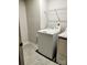 Clean laundry room with tile flooring, wire shelving, and modern washer and dryer at 1598 Respect St, Concord, NC 28027
