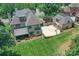 This aerial view showcases the home, sport court, lush lawn, pristine landscaping, and a charming neighborhood at 1728 Shadow Forest Dr, Matthews, NC 28105