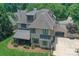 Aerial view of the rear exterior showcasing the porte cochere, patio, basketball court, and manicured landscaping at 1728 Shadow Forest Dr, Matthews, NC 28105