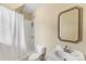 This bathroom features a shower with a white curtain, toilet, and a white vanity with an ornate mirror at 1728 Shadow Forest Dr, Matthews, NC 28105