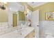 Bright bathroom featuring subway tile, marble countertop, and a large mirror reflecting the adjacent bedroom at 1728 Shadow Forest Dr, Matthews, NC 28105
