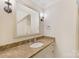 Bathroom featuring a beige marble countertop, decorative sconces, and neutral tones for a relaxing feel at 1728 Shadow Forest Dr, Matthews, NC 28105