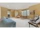 This bonus room features neutral carpet, a sofa, two chairs, a window, and ample space for a relaxing atmosphere at 1728 Shadow Forest Dr, Matthews, NC 28105
