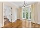 Versatile bonus room with hardwood floors, a large window, and neutral tones, perfect for customization at 1728 Shadow Forest Dr, Matthews, NC 28105