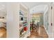 Dining room with a bookshelf, round table, chandelier, and doorway to kitchen at 1728 Shadow Forest Dr, Matthews, NC 28105
