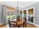 Formal dining room features wood floors, chandelier, and French doors to outside at 1728 Shadow Forest Dr, Matthews, NC 28105