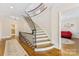 Elegant foyer featuring a curved staircase with wrought iron railing and hardwood floors at 1728 Shadow Forest Dr, Matthews, NC 28105