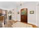 Elegant foyer showcasing the hardwood floors, chandelier, fireplace, and wood front door at 1728 Shadow Forest Dr, Matthews, NC 28105