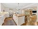 Bright kitchen with an island, stainless steel appliances, and hardwood floors at 1728 Shadow Forest Dr, Matthews, NC 28105