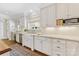 Well-lit kitchen with marble countertops, custom cabinets, and stainless steel appliances at 1728 Shadow Forest Dr, Matthews, NC 28105