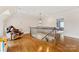 Spacious landing area with hardwood floors, a comfortable chair, and natural light at 1728 Shadow Forest Dr, Matthews, NC 28105
